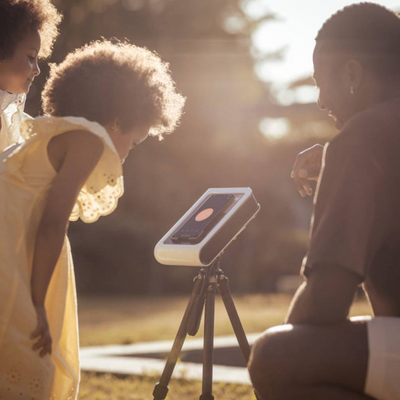 a group of people looking at a device