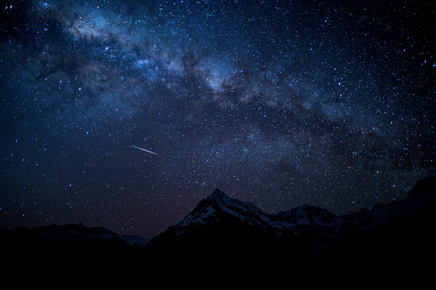 a starry sky over mountains