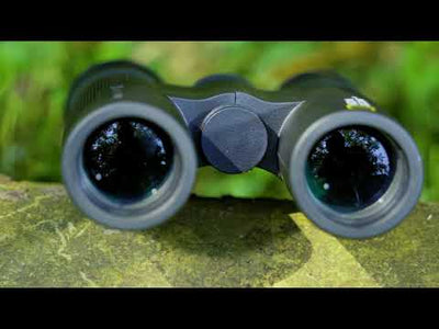 a black binoculars on a rock