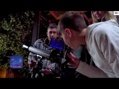 a man looking through a telescope